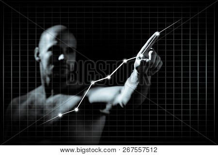 Young Man In Growth Concept With A Graph.serious Man Drawing Strategy On Virtual Screen On Dlack Iso