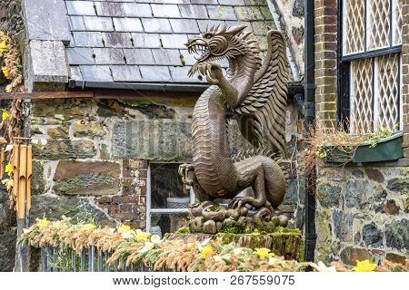 Beddgelert , Wales - May 03 2018 : Wooden Dragon Standing In The Historic Town