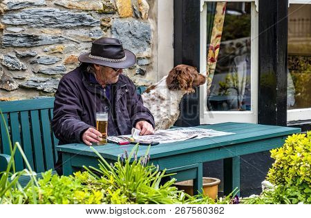 Beddgelert , Wales - May 03 2018 : Man And Dog Enjoying The Traditional Town