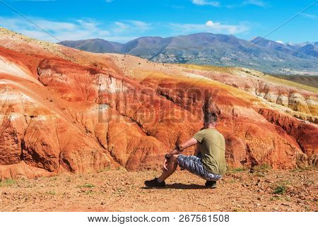 Relaxing man in Valley of Mars landscapes in the Altai Mountains, Kyzyl Chin, Siberia, Russia
