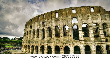 Mad Clouds And Colisseum Old Building In Rome City, Italy