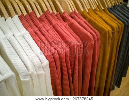 Multi-colored T-shirt Hanging In The Lining Of The Shopping Mall.