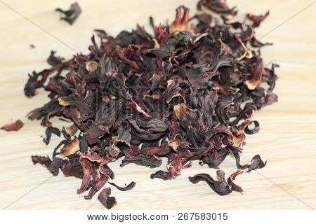 Dry Carcade Sudanese Rose On Wooden Desk