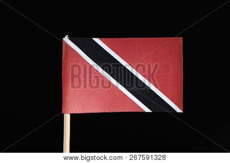 A Official And Original Flag Of Trinidad And Tobago On The Toothpick On Black Background. A Red Fiel