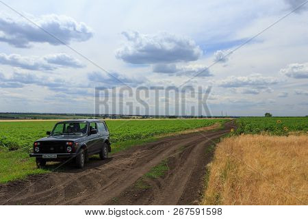 Dnipropetrovsk Region, Ukraine - July 08, 2017: Vaz Niva Blue-green Color On The Dirt Road Through T