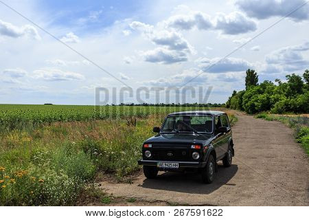 Dnipropetrovsk Region, Ukraine - July 08, 2017: Vaz Niva Blue-green Color On The Road Near The Sunfl