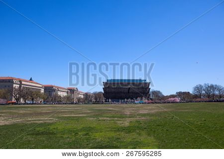 WASHINGTON, DC, USA - MARCH 31, 2018:  Exterior view of Smithsonian  National Museum of African American History and Culture (NMAAHC) on the Blossom Kite Festival  in Washington DC monumental park