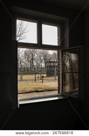 Auschwitz, Poland - March 30 2012 Melancholic View Through A Window Of A Concentration Camp Barrack 
