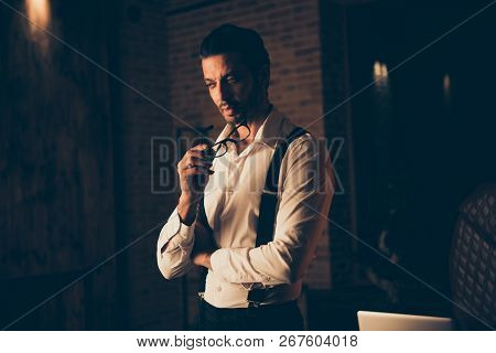 Half Turn Attractive Calm Un-shaven Man Hold Eyeglasses Spectacles In Hand Look Down Aside Stand Ind