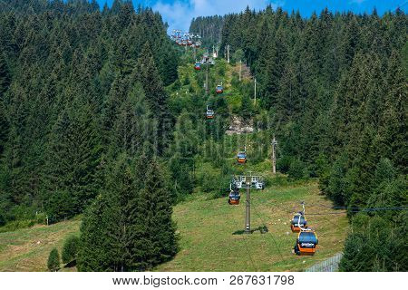 Bad Gastein, Austria - August 06, 2018: Air Cableway To The Top Of The Hill Through A Forest Path.