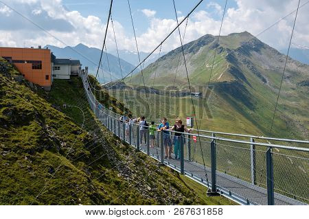 Bad Gastein, Austria - August 06, 2018: People Cross A Suspension Bridge On The Stubnerkogel, Gastei