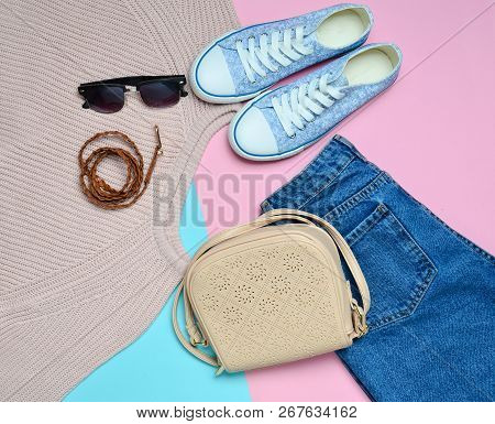 Women's Clothing, Shoes And Accessories On A Blue Pink Pastel Background. Fashionable Look. Sneakers
