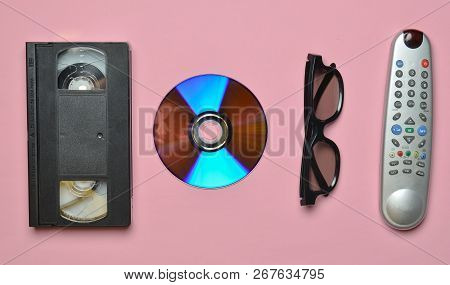 Remote Controller, 3d Glasses, Cd, Video Cassette On A Pink Pastel Background. Retro Technology.