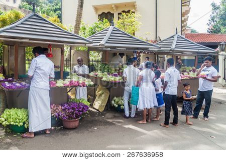 Kandy, Sri Lanka - July 19, 2016: White Clothed Buddhist Devotees Buy Lotus Flowers During Poya Full