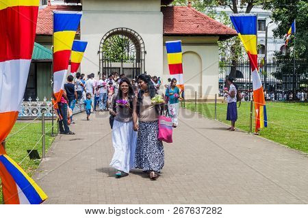 Kandy, Sri Lanka - July 19, 2016: Buddhist Devotees Visit Temple Of The Sacred Tooth Relic During Po