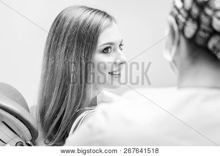Dentist Examine Female Patient With Braces In Denal Office.