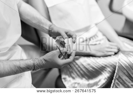 Dentist Examine Female Patient With Braces In Denal Office.