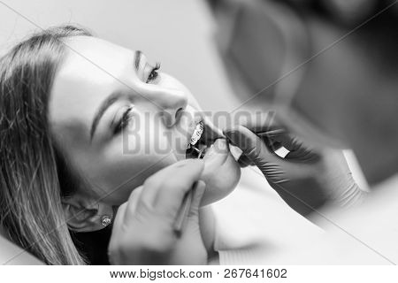 Dentist Examine Female Patient With Braces In Denal Office.