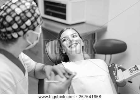 Dentist Examine Female Patient With Braces In Denal Office.