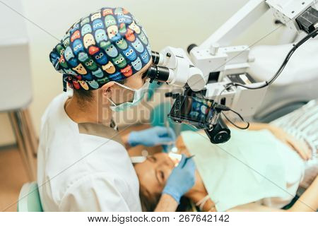 Dentist Examine Oral Cavity Of Female Patient With Microscope, Up View.