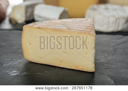 A French Morbier Cheese On A Slate Plate