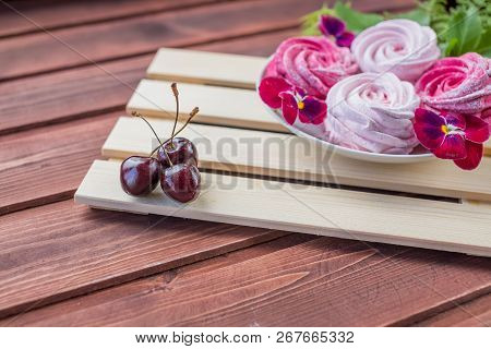 Pink Homemade Zephyr Or Marshmallow With Cherry Berry And Flowers On Light Wooden Background. Marshm