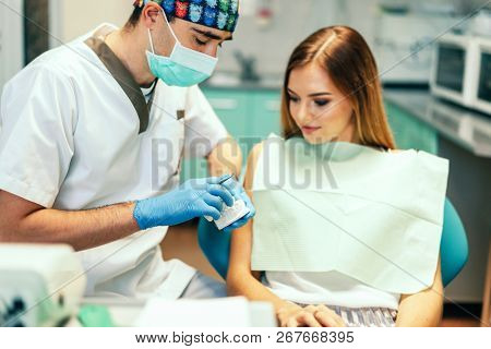Dentist Examine Female Patient With Braces In Denal Office.