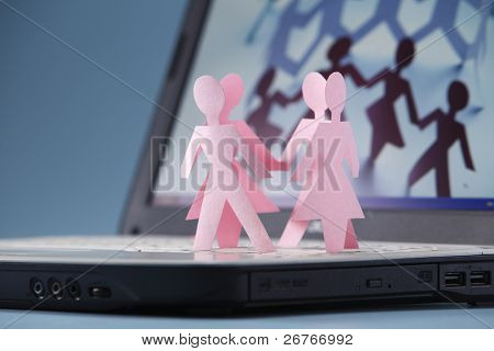 Paper chain dancing on a laptop.