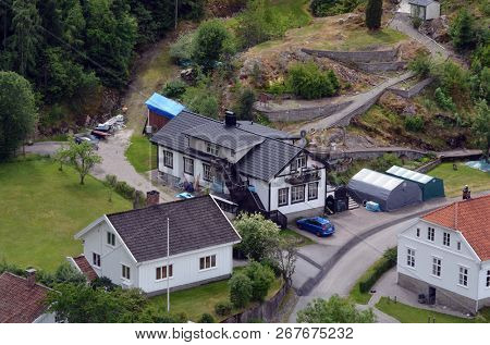 Typical Swedish nature and houses on the shore of the fjord. View from the high bridge over the fjord. The border of Norway and Sweden.June 18,2018.Near the town Selater,Sweden
