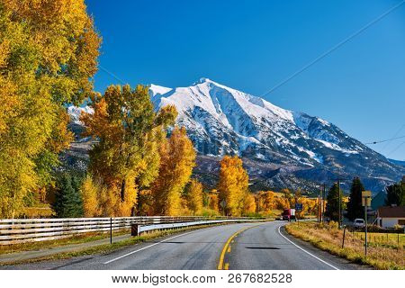 Highway in Colorado Rocky Mountains at autumn, USA. Mount Sopris landscape.
