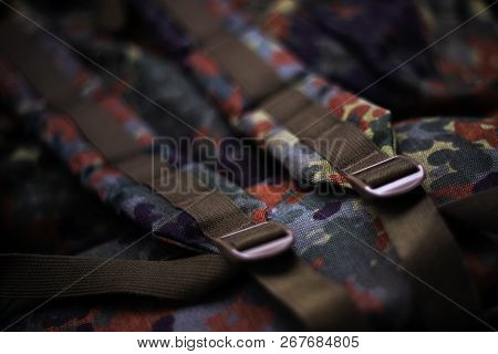 Military Camouflage Roomy Backpack. In The Frame Of The Strap And The Back Of A Backpack. Close-up V