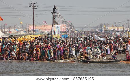 ALLAHABAD, INDIA - FEBRUARY 12, 2013: Thousands of Hindu devotees come to confluence of the Ganges and Yamuna River for holy dip during the festival Kumbh Mela. The world's largest religious gathering