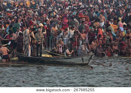 ALLAHABAD, INDIA - FEBRUARY 12, 2013: Thousands of Hindu devotees come to confluence of the Ganges and Yamuna River for holy dip during the festival Kumbh Mela. The world's largest religious gathering