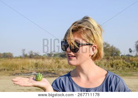 Girl With A Small Watermelon In Her Hand. The Embryo Of Watermelon
