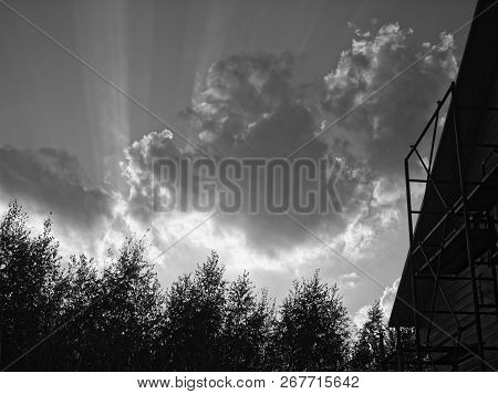 Bright Rays Of The Sun From Behind The Clouds, Black And White Photo