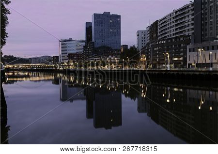 View Of A Zubizuri Bridge,over The Nervion River, In A Cloud Day, Between The Towers Of Bilbao, Vizc