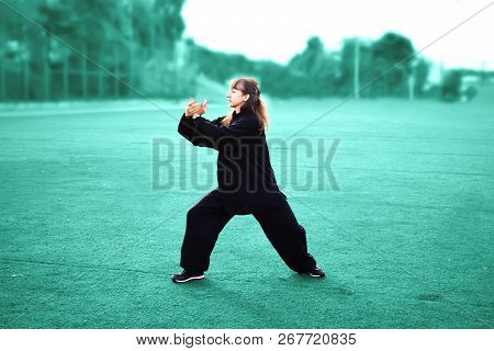 Taichi Wushu Master Woman Outdoors In Move