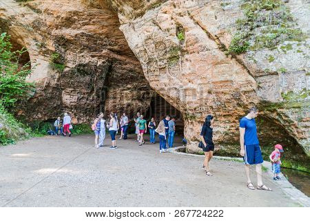 Sigulda, Latvia - August 20, 2016: People Visit Gutmana Cave Near Sigulda Latvia