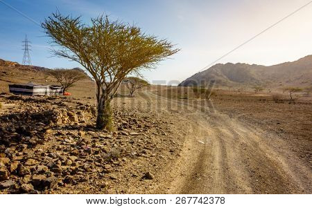 Dirt road in Al Hajar mountains in Fujairah, UAE and a tent