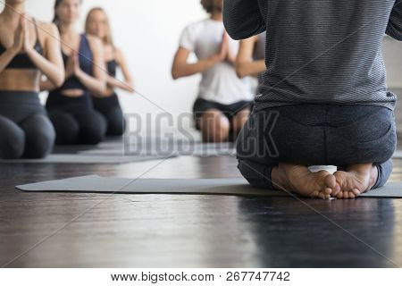 Group Of Sporty People In Vajrasana Exercise, Close Up