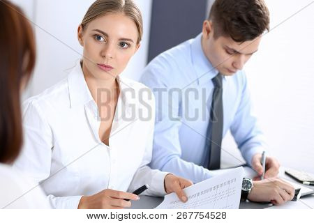 Group Of Business People Or Lawyers Discussing  Terms Of Transaction In Office. Colleagues Working A