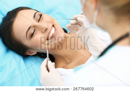 Young Female Patient Visiting Dentist Office.beautiful Woman With Healthy Straight White Teeth Sitti