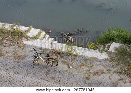Throw Off The Bike In The River Tibur In Rome, Italy.