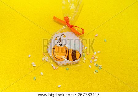 Gingerbread Bee On Yellow Background With Paints Near It