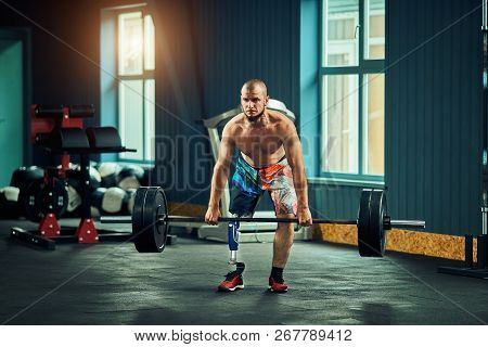 Sportsman With Prosthesis Working Out In Gym