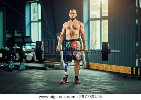 Sportsman With Prosthesis Working Out In Gym