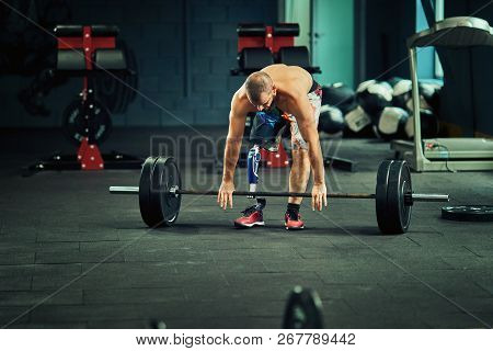 Sportsman With Prosthesis Working Out In Gym