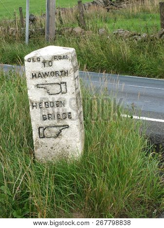 An Old Stone Direction Marker On The Old Road Between Howarth And Hebden Bridge With Carved Fingers 