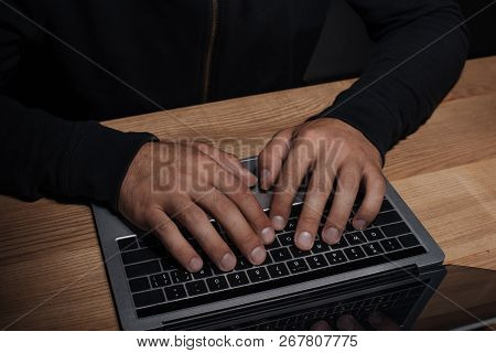 Cropped Shot Of Hacker Using Laptop At Wooden Tabletop, Cuber Security Concept