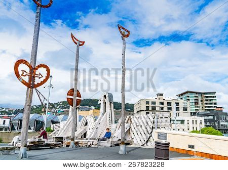 Wellington, New Zealand - October 1 2018; Two People Sit Among City To Sea Wooden Sculpture By Parat